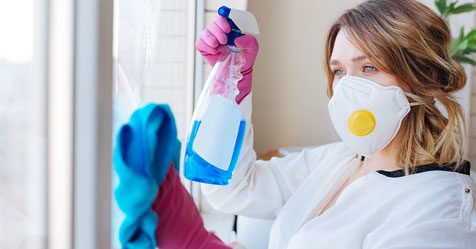 woman cleaning with mask