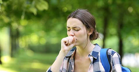 Woman coughing in summer