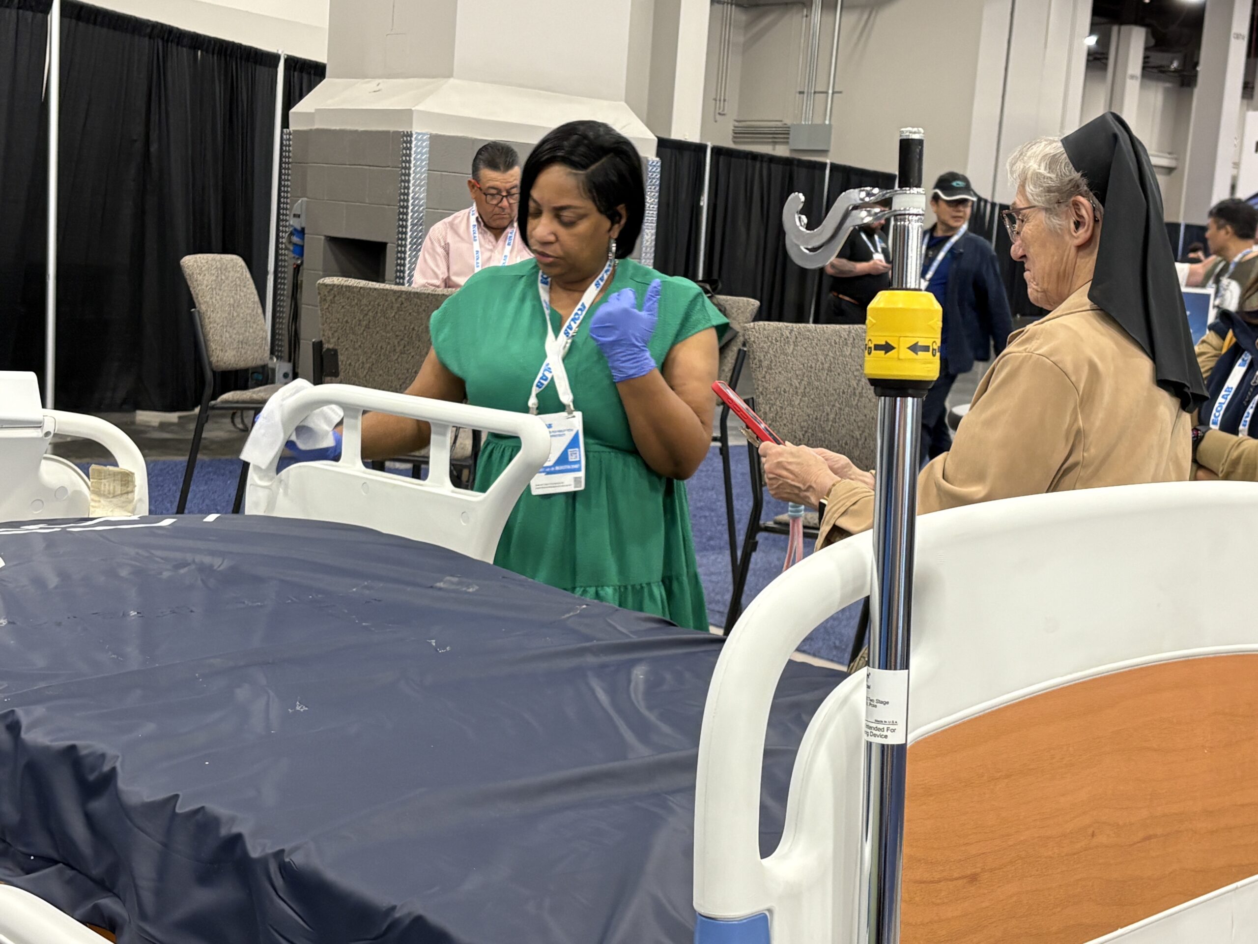 Marilyn Clifton from La Rabida Children's Hospital doing a demo of how to clean hospital beds at the healthcare booth. 