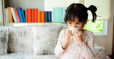 little girl sneezing