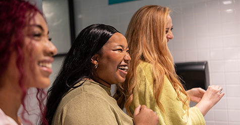 women laughing in restroom